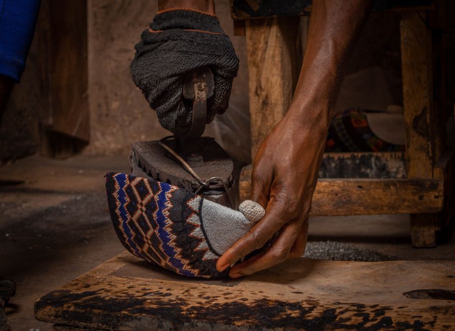 Close-up of an artisan's hands crafting by hand at a workshop bench