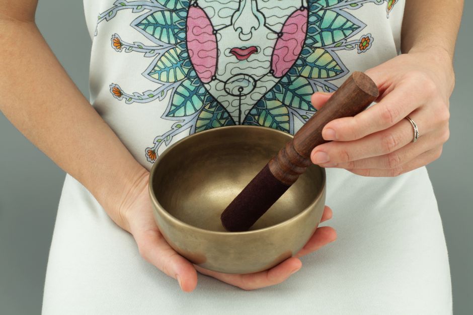 Hand-hammered metal singing bowl with wooden striker